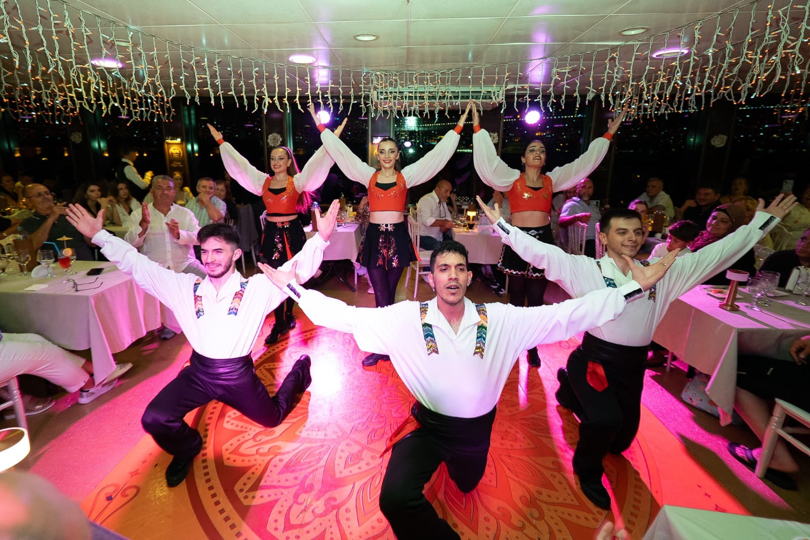 Turkish folk dance performers on stage during the Bosphorus dinner cruise evening show