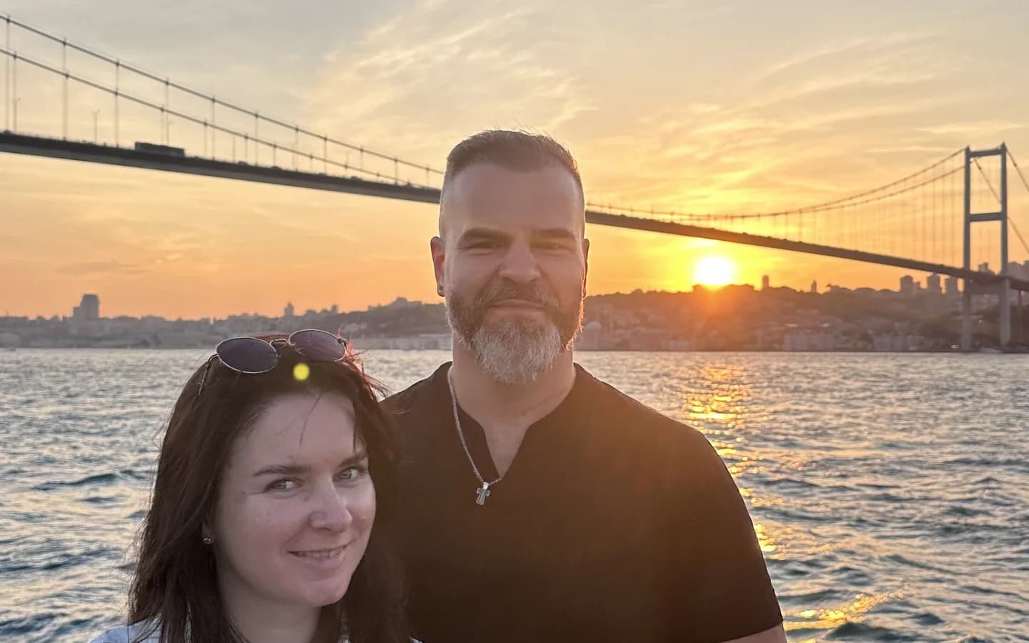 Bosphorus dinner cruise at sunset with illuminated mosques and the Istanbul skyline reflected on the water