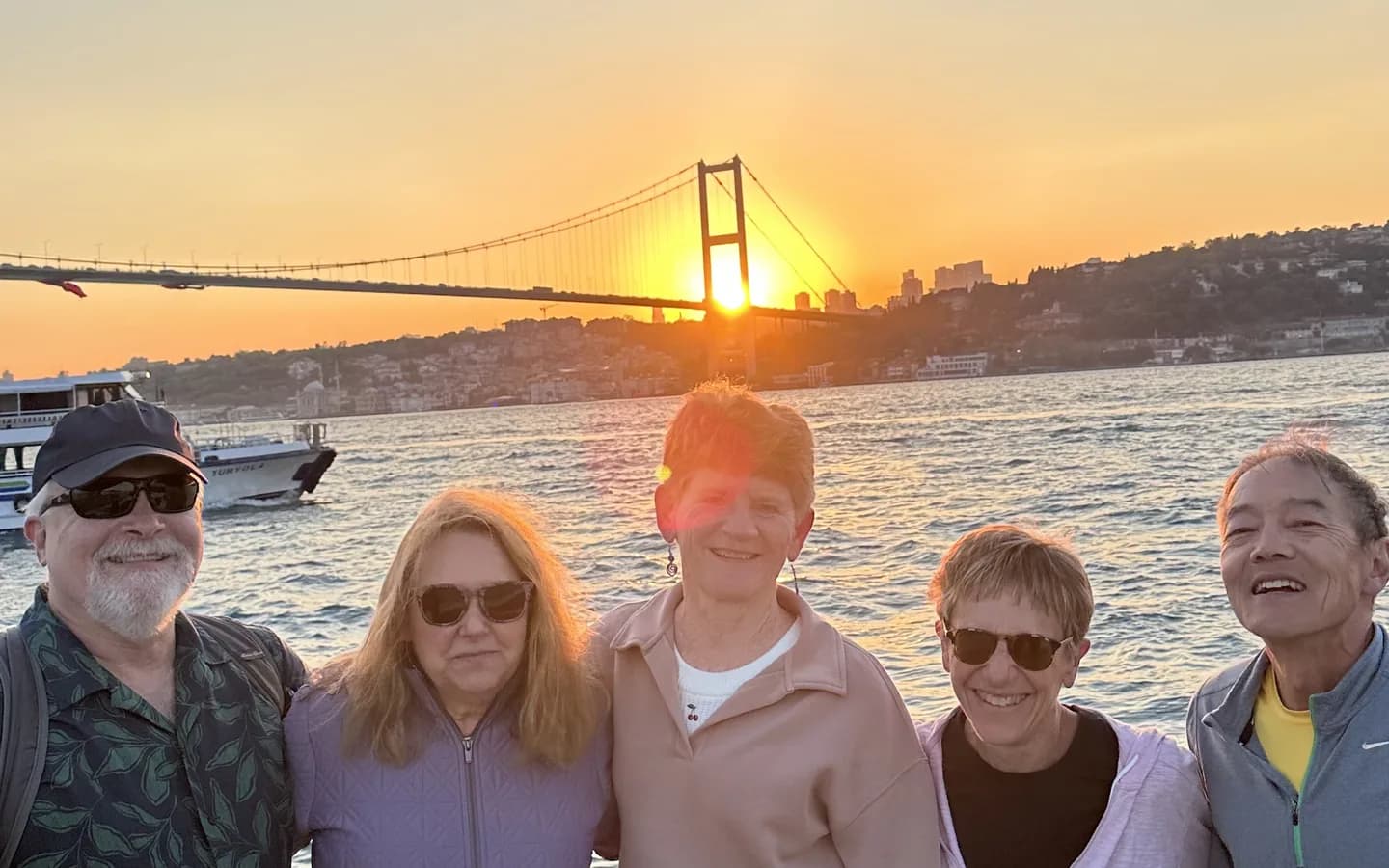 Golden sunset over the Bosphorus strait with Ortaköy Mosque and Istanbul skyline silhouette