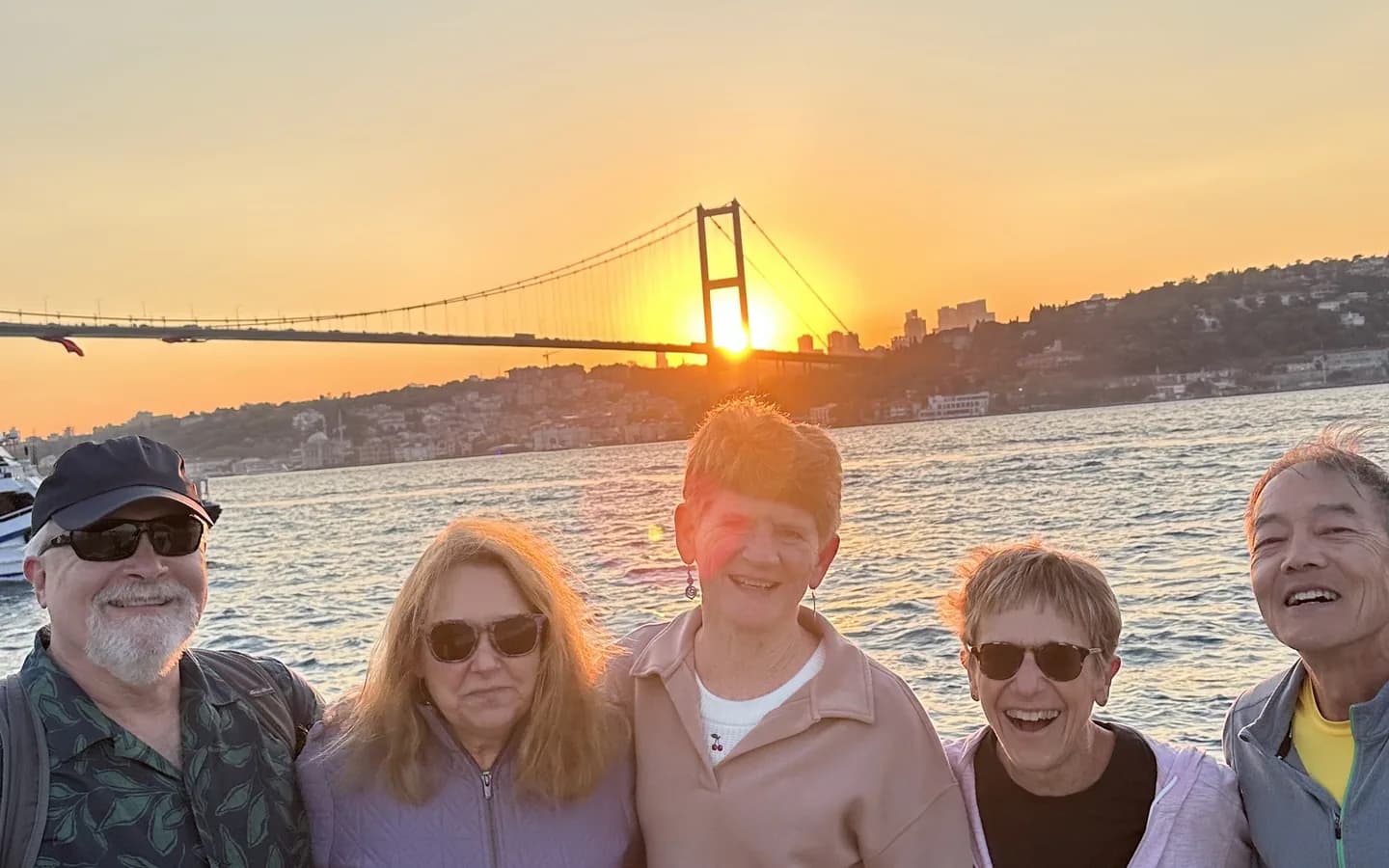 Birthday party celebration on a private yacht on the Bosphorus at sunset with balloons and Istanbul skyline