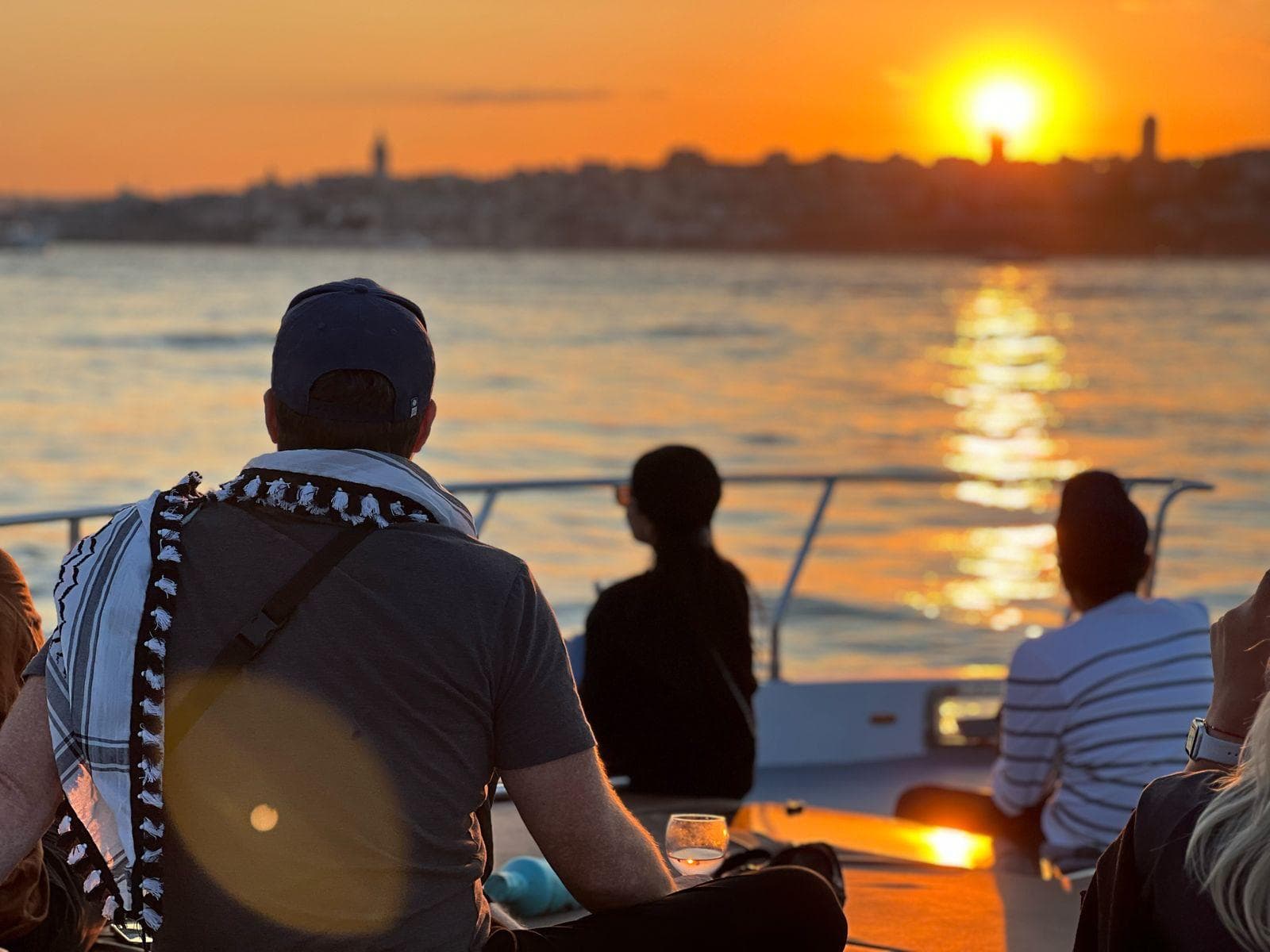 Side-by-side view of a tour boat with guide and a public Istanbul ferry on the Bosphorus
