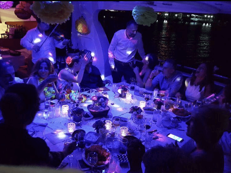 A candlelit table set for a celebration on a yacht