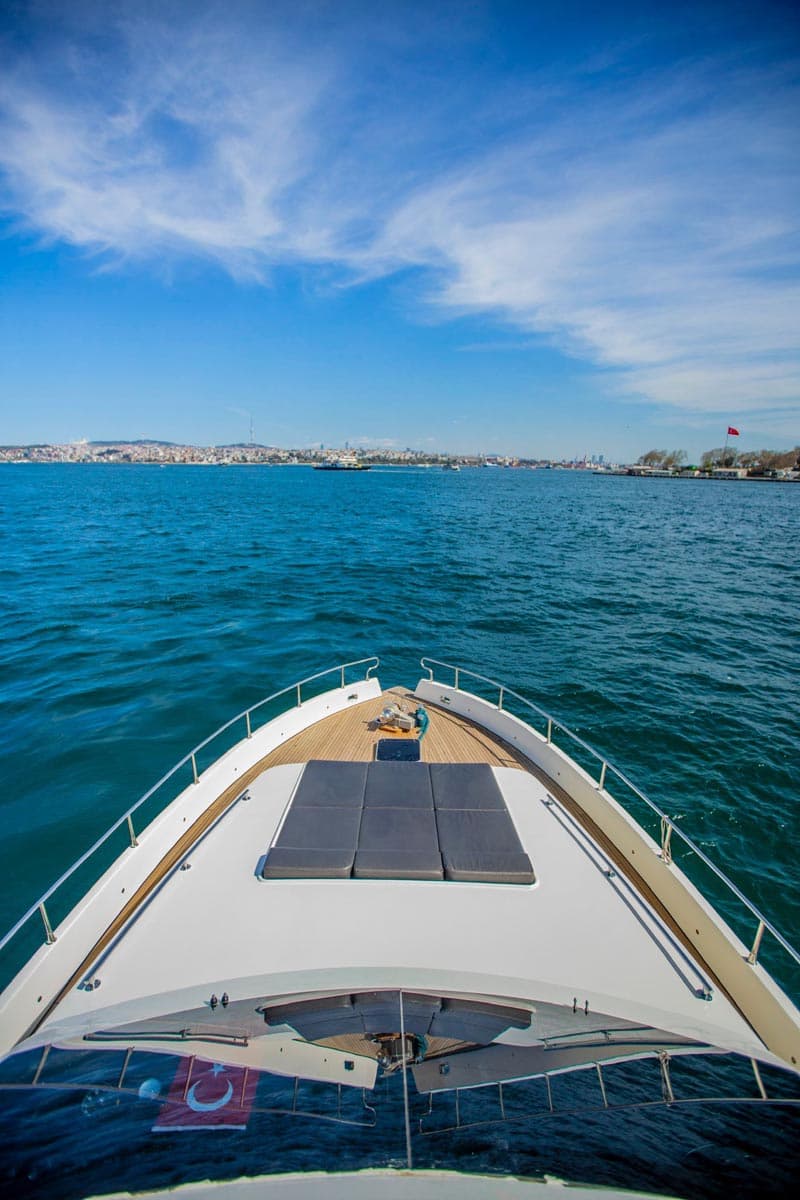 The bow of a yacht heading out to open water