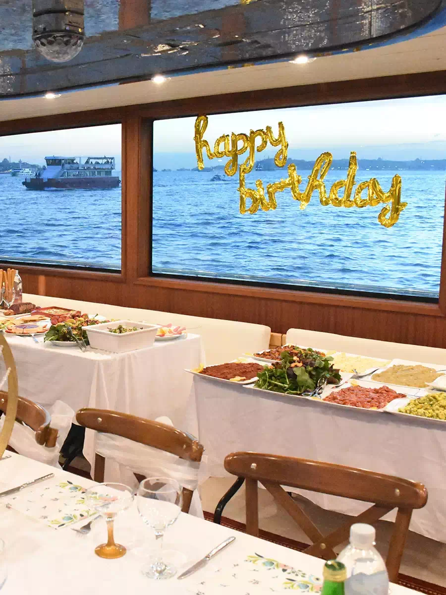 A happy birthday banner over a buffet table